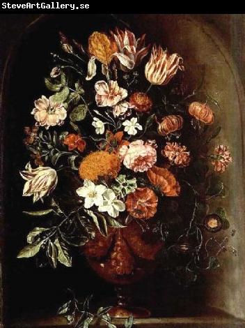 unknow artist A still life with tulips, roses, a red turban cup lily, auricula, jasmin, an iris, carnations and other flowers in a vase, all in a stone niche.